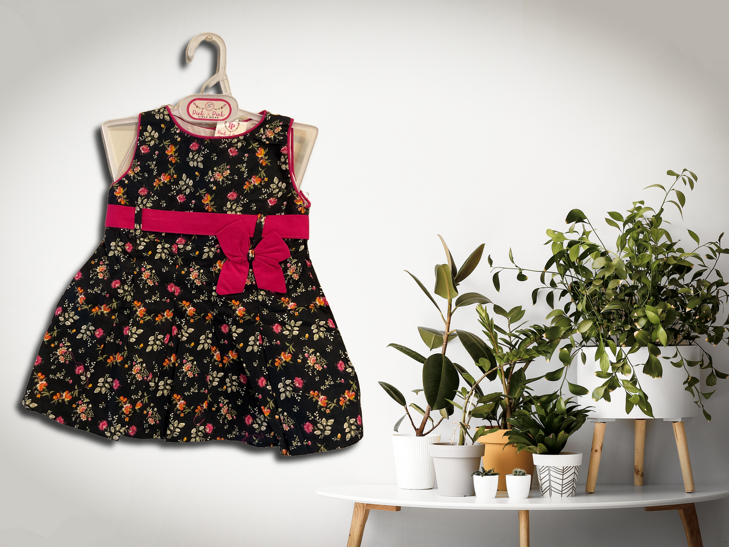 Floral Black Sleeveless Frock with Pink Bow Accent